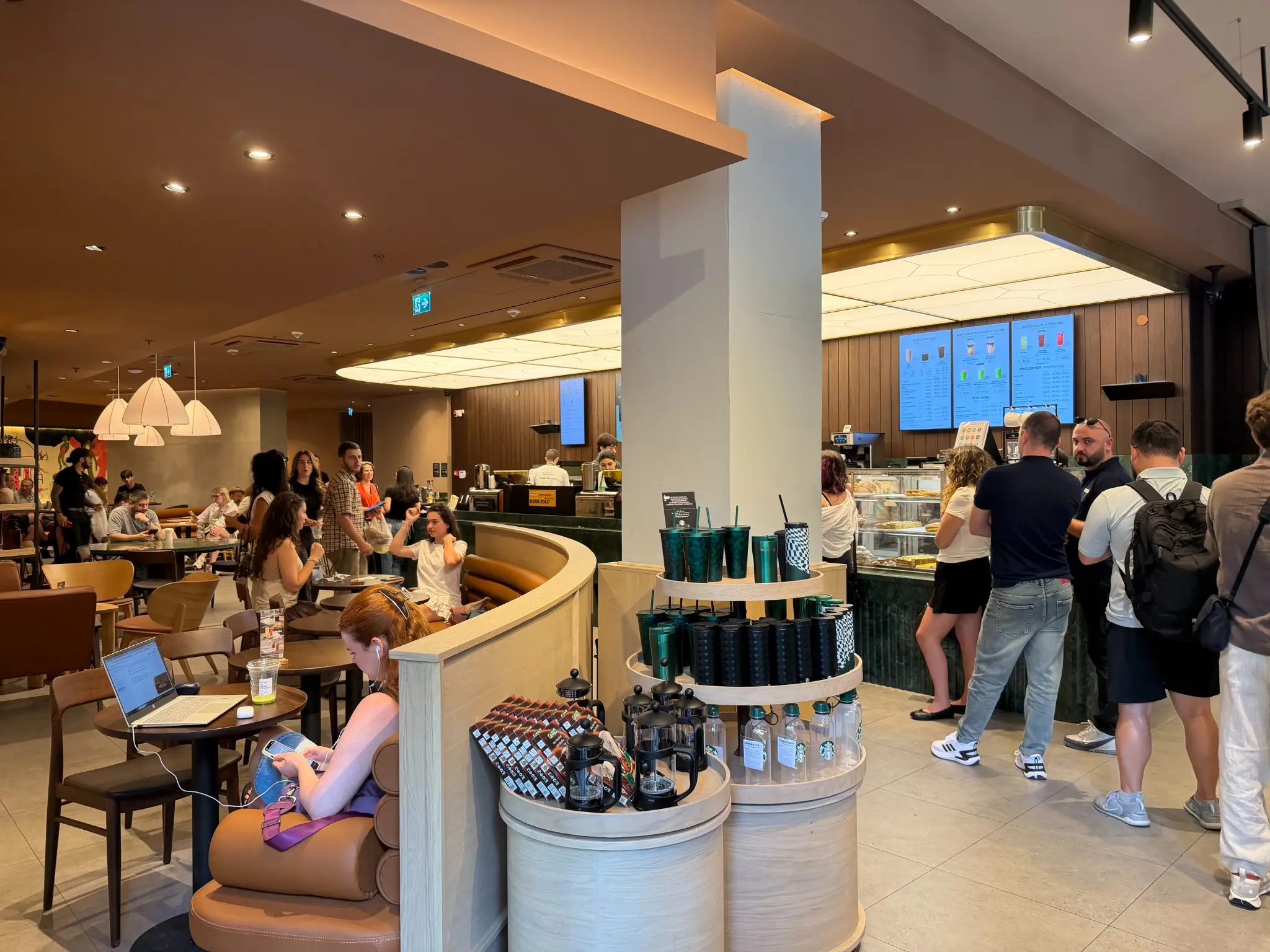 Customers and service counter inside the first Starbucks in Tbilisi